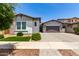 Beautiful single-story home featuring a two-car garage, paver driveway, manicured lawn, and stone facade accents at 3856 E Shannon St, Gilbert, AZ 85295