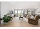 Spacious living room with a comfortable seating arrangement, decorative fireplace, and large windows showcasing the view at 3856 E Shannon St, Gilbert, AZ 85295