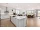 Bright, open-concept living space with a modern kitchen island, stainless steel appliances, and a cozy seating area at 3856 E Shannon St, Gilbert, AZ 85295