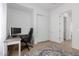 Bright office space with a computer setup, a comfortable chair, and a closet for storage at 3856 E Shannon St, Gilbert, AZ 85295