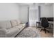Comfortable office area with sofa, desk setup, light-filled window and neutral colors at 3856 E Shannon St, Gilbert, AZ 85295