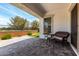 Inviting covered patio with pavers, comfortable seating, and a view of the landscaped backyard at 3856 E Shannon St, Gilbert, AZ 85295