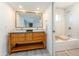 Bright bathroom featuring a double sink vanity, marble floors, and a shower and tub combination at 4033 W Sharon Ave, Phoenix, AZ 85029