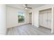 Bright bedroom featuring a large window, open closet, and light gray flooring at 4033 W Sharon Ave, Phoenix, AZ 85029