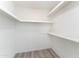 This is a walk in closet with white walls, a gray floor, and white shelving at 4033 W Sharon Ave, Phoenix, AZ 85029