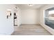 Bright dining area featuring an open concept layout with large window, hardwood floors, and neutral color scheme at 4033 W Sharon Ave, Phoenix, AZ 85029