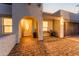 Inviting front entrance with arched doorway, textured walls, and brick-paved walkway leading to a well-lit front door at 4033 W Sharon Ave, Phoenix, AZ 85029