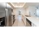 Updated kitchen with stainless steel appliances, white cabinets, quartz countertops, and modern fixtures at 4033 W Sharon Ave, Phoenix, AZ 85029