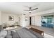 Spacious main bedroom features a ceiling fan, neutral walls and an exterior door to the backyard at 4033 W Sharon Ave, Phoenix, AZ 85029