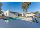 A refreshing pool with a modern deck and a covered lounge area enhances the backyard of this property at 4033 W Sharon Ave, Phoenix, AZ 85029