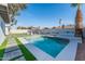 Beautiful backyard pool with a grass paver design and pristine landscaping at 4033 W Sharon Ave, Phoenix, AZ 85029