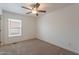 Neutral carpeted bedroom with bright light and ceiling fan at 46 S 96Th St, Mesa, AZ 85208
