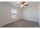Bright bedroom featuring a window and ceiling fan at 46 S 96Th St, Mesa, AZ 85208