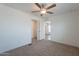 Carpeted bedroom with a ceiling fan and access to the bathroom at 46 S 96Th St, Mesa, AZ 85208