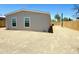 Back view of a well-maintained house, showing the side yard with a wooden fence and gravel landscape at 46 S 96Th St, Mesa, AZ 85208