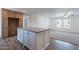 A kitchen island is adjacent to a living area creating an open concept home at 46 S 96Th St, Mesa, AZ 85208