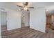 This living room has a ceiling fan and multiple access points to other rooms at 46 S 96Th St, Mesa, AZ 85208