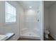 Bright bathroom showcasing a step-in shower with white tiled walls and a window for natural light at 46 S 96Th St, Mesa, AZ 85208