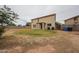 Large backyard featuring some dead grass, a concrete border, and a partial view of the home's exterior at 4804 S 25Th Dr, Phoenix, AZ 85041