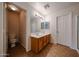 Bright bathroom featuring a double sink vanity and well-lit mirror at 4804 S 25Th Dr, Phoenix, AZ 85041