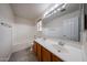 Bright bathroom featuring double sinks, a bathtub with shower, and tiled floors at 4804 S 25Th Dr, Phoenix, AZ 85041