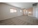 Light-filled bonus room featuring neutral walls, carpet, and multiple windows with wood blinds at 4804 S 25Th Dr, Phoenix, AZ 85041