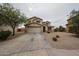 Attractive two-story home featuring a spacious driveway and well-maintained desert landscaping at 4804 S 25Th Dr, Phoenix, AZ 85041