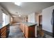 Open kitchen with island, wood cabinets, tile floor, and adjacent living room provides ample space at 4804 S 25Th Dr, Phoenix, AZ 85041