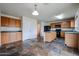 Inviting kitchen features wood cabinets, island, black appliances, and stylish tile flooring at 4804 S 25Th Dr, Phoenix, AZ 85041