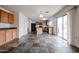 Bright kitchen features wood cabinets, black appliances, island, and sliding glass door to the backyard at 4804 S 25Th Dr, Phoenix, AZ 85041