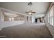 Open-concept living area connecting to the kitchen featuring neutral carpet and natural light at 4804 S 25Th Dr, Phoenix, AZ 85041