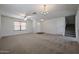 Spacious living room featuring carpet, large windows, and open floor plan at 4804 S 25Th Dr, Phoenix, AZ 85041