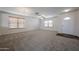 Bright living room featuring neutral carpet, modern lighting and plenty of space at 4804 S 25Th Dr, Phoenix, AZ 85041