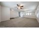 Expansive living room with neutral carpet, ceiling fan, and ample natural light at 4804 S 25Th Dr, Phoenix, AZ 85041