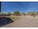 Spacious backyard featuring gravel landscaping and a fenced perimeter, perfect for outdoor activities at 5096 S 245Th Dr, Buckeye, AZ 85326