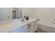 Bathroom vanity with a soaking tub and a shower behind a glass wall at 5096 S 245Th Dr, Buckeye, AZ 85326