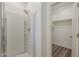Bright bathroom featuring a walk-in shower and a spacious walk-in closet for optimal storage at 5096 S 245Th Dr, Buckeye, AZ 85326