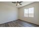 Well-lit bedroom featuring a modern ceiling fan and a window with a view of the surroundings at 5096 S 245Th Dr, Buckeye, AZ 85326