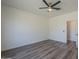 Bright bedroom with wood floors, ceiling fan and view of an entryway at 5096 S 245Th Dr, Buckeye, AZ 85326