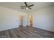 Large bedroom features wood floors and multiple doors leading to the bathroom and closet at 5096 S 245Th Dr, Buckeye, AZ 85326
