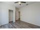 Bedroom with a sliding door closet, featuring vinyl wood floors and natural light from a window at 5096 S 245Th Dr, Buckeye, AZ 85326