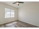 Bright, airy bedroom with a ceiling fan and natural light, hardwood flooring at 5096 S 245Th Dr, Buckeye, AZ 85326