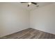 Bright, empty bedroom with a ceiling fan and hardwood flooring, ample wall space at 5096 S 245Th Dr, Buckeye, AZ 85326