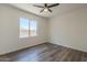 Bedroom with a ceiling fan and a large window offering natural light and a view of the outdoors at 5096 S 245Th Dr, Buckeye, AZ 85326