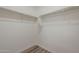 Walk-in closet with white walls and racks with wood floors at 5096 S 245Th Dr, Buckeye, AZ 85326