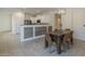 Bright dining room features table, chairs, modern lighting and bar top to kitchen at 5096 S 245Th Dr, Buckeye, AZ 85326