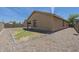 Exterior view displaying gravel landscaping, neutral paint, and covered patio; ideal for relaxation at 5096 S 245Th Dr, Buckeye, AZ 85326