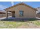 Back exterior view showing the covered patio, neutral paint, and manicured surroundings of the residence at 5096 S 245Th Dr, Buckeye, AZ 85326