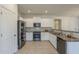 Modern kitchen with stainless steel appliances, granite countertops, and white cabinetry at 5096 S 245Th Dr, Buckeye, AZ 85326
