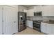 Well-lit kitchen featuring stainless steel appliances, subway tile backsplash, and white cabinets at 5096 S 245Th Dr, Buckeye, AZ 85326